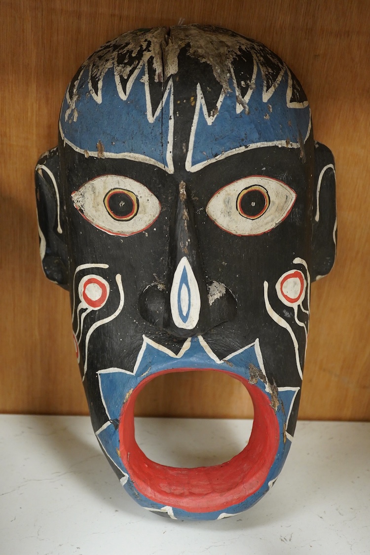 An African hardwood throwing club together with a painted mask and a Caucasian style dagger kindjal, largest 34cm high